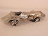 a silver toy car that is sitting on a table