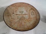 a brown plate with a drawing of a living room on it
