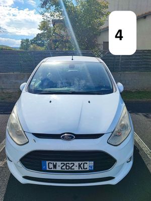 a white car that is parked in the parking lot