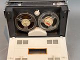 a laptop computer with two reels on top of it
