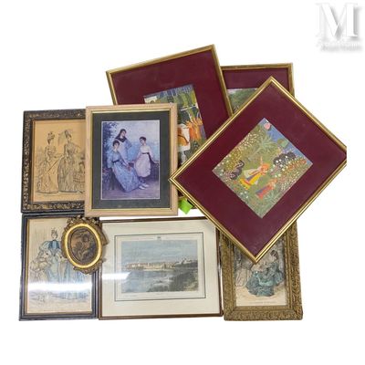 many framed pictures on a table with a pair of scissors