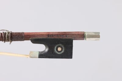 a close up of a violin bow on a white background