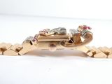 a picture of a gold bracelet with a dragon on it