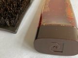 a brush and a brush holder sitting on a table