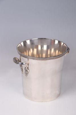 an antique silver plated ice bucket with handles on a white background