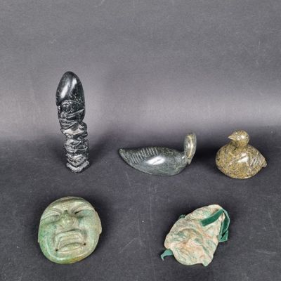 a group of four pieces of glass and metal on a black surface