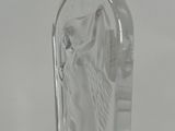 a clear glass vase with a statue of a woman on it