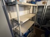 a refrigerator and shelves in a room with a lot of stuff