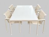 a white table with six chairs around it