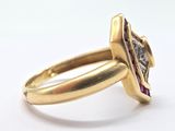 an image of a gold ring with a diamond and a ruby stone