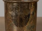 a silver cup that is sitting on a table