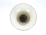 an overhead view of a wine glass with a brown liquid in it