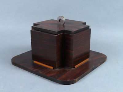 a small wooden box with a key on top of it