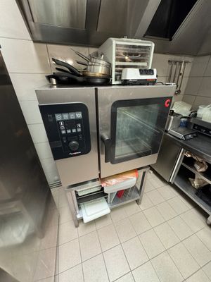 a large oven in the middle of a kitchen with pots and pans in it