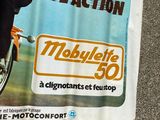 a poster of a woman riding a motorcycle on the street