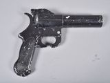 a small gun that is on a white surface