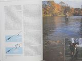 an open book with a picture of a man fishing in the water