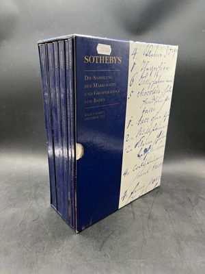 a set of three books with signatures on them sitting on a table