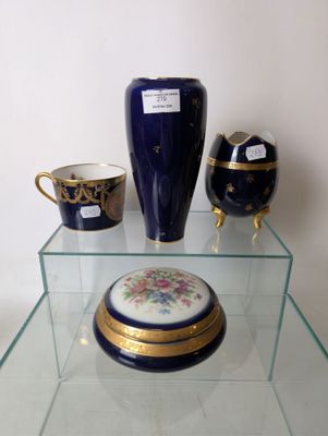 a glass shelf with a vase and other decorative items on it