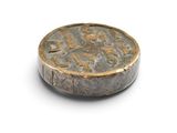 an old coin is sitting on top of a white surface
