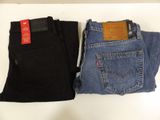 two pairs of levi ' s jeans are sitting on a table