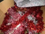 a box with tinsel and a pair of shoes in it