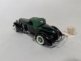 a model of a black car with a green top