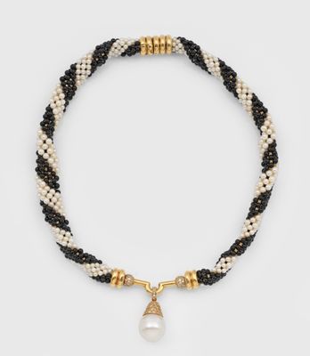 a black and white beaded necklace with a pearl charm