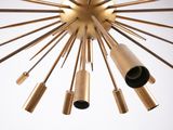 a close up of a chandelier made of brass pipes and tubes