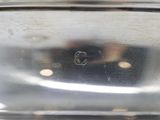 a close up of a silver plate with a hole in it