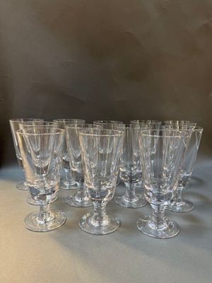six clear wine glasses lined up on a table