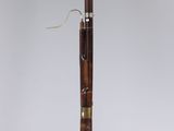 a wooden pen sitting on top of a glass stand