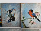 two paintings of birds sitting on a branch of a tree