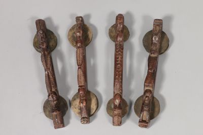 four pieces of wood and metal are sitting on a white surface