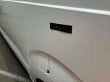 a close up of a white car with a sticker on it