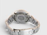 the back of a watch on a white surface with a white background