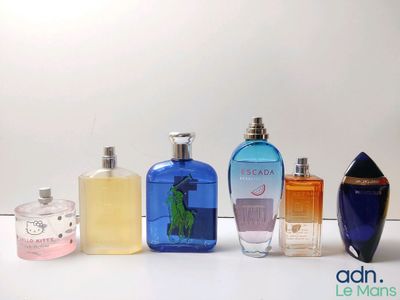 several different types of perfume bottles lined up on a white surface