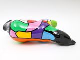 brightly colored dog figurine on a white surface with a white background