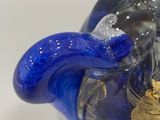 a blue glass vase with a gold decoration on it