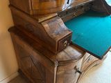 a wooden cabinet with a green mat on top of it