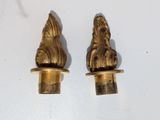 two gold colored candlesticks with a lion head on them