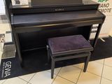 a piano and stool in a store with a mirror