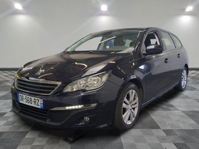 the black car is parked on a checkered floor in the garage