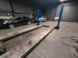 a car that is parked in a garage next to a ramp