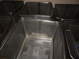 four deep fryers lined up in a row