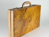 a brown suitcase with a handle on a white background