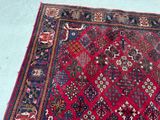 rug on the floor is red and blue with a pattern on it