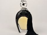 an image of a bottle of perfume with a tassel on it