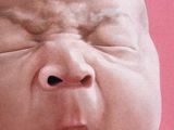 a picture of a baby with its mouth open on a magazine cover