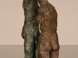 statue of a boy and a girl kissing on a table